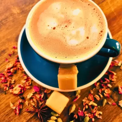 Black cup with foamy milk tea.