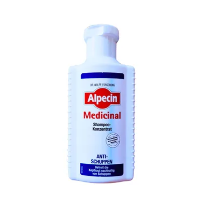 Alpecin Anti Dandruff in a white bottle with red and dark blue motiv label.