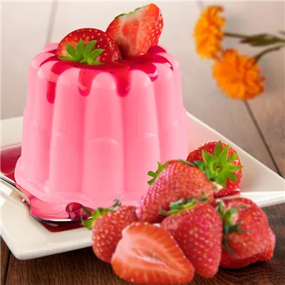 On a square dessert plate, a Pink Strawberry Pudding topped with strawberry compote and garnished with fresh cut strawberries.