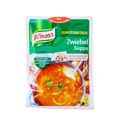 Onion Soup instant soup mix in Knorr green sachet with picture of orangey onion soup in a bowl garnished with basil.