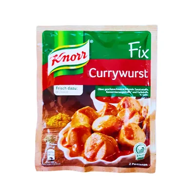 Knorr Currywurst mix in sachet with picture of bowl containing sliced sausages drizzled with sauce.