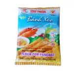 Banh Xeo Asian Pancake flour in a blue plastic packet with yellow pancakes on a plate and 2 shrimps.